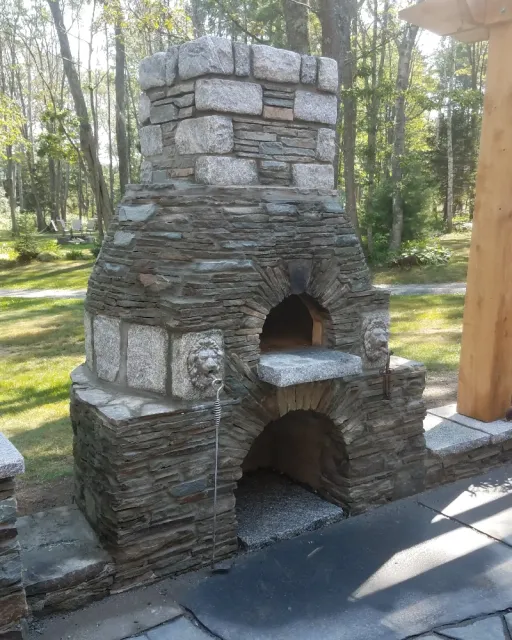 Custom outdoor pizza oven with lion medallions in Greater Portland