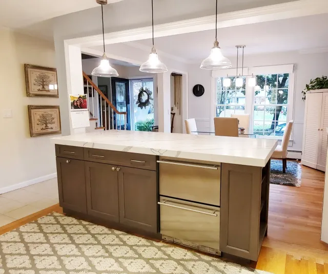 A kitchen with a large island and stainless steel appliances.