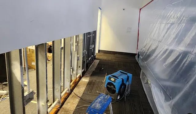 Office hallway undergoing water damage restoration