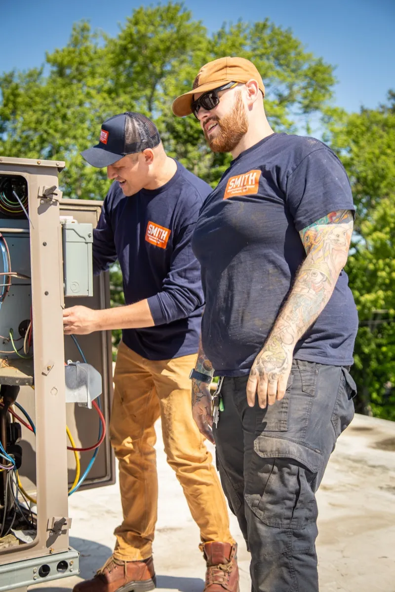 Technicians at HVAC panel