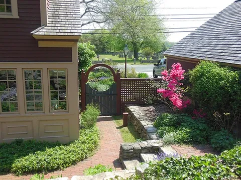 custom fence and entryway to the backyard of a beautiful coastal New England house