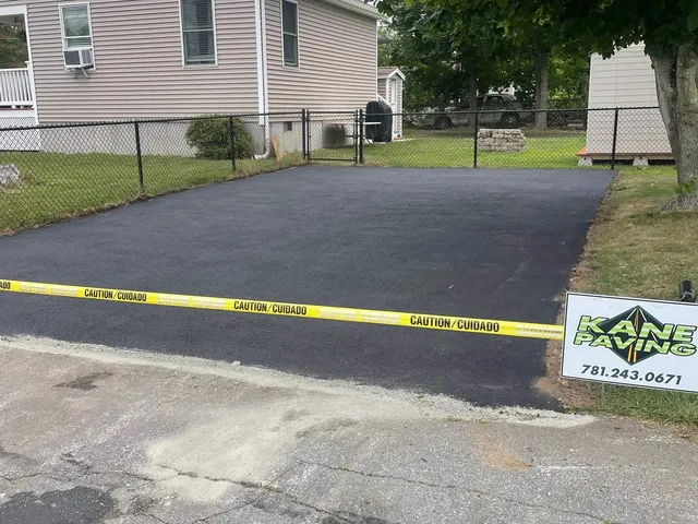 Finished asphalt driveway with stone curb