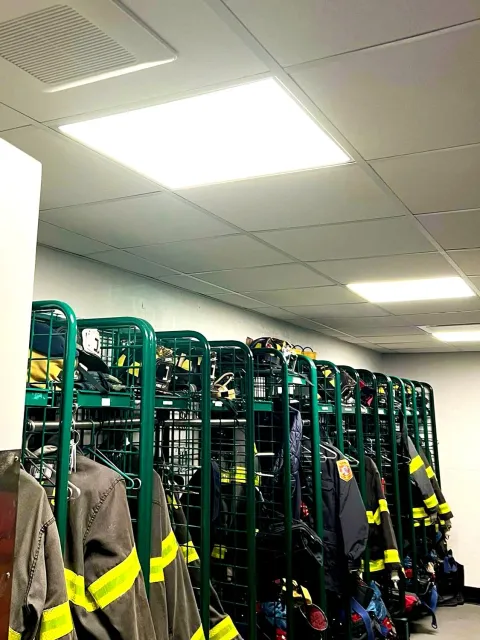 The interior of a fire station locker room with new ceiling lights.