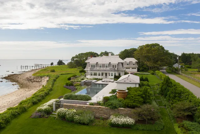 Aerial of a coastal estate with pool, spa and layered garden terraces