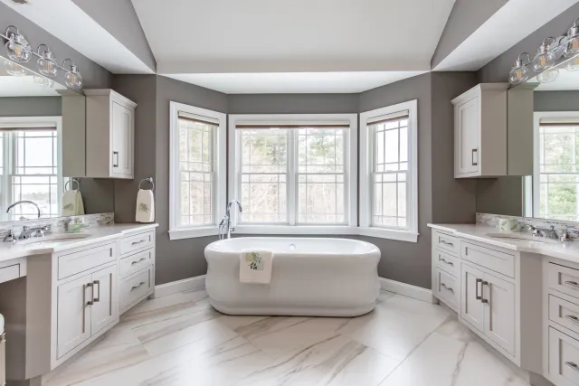 An expansive bathroom showcasing a bathtub alongside a sleek sink.