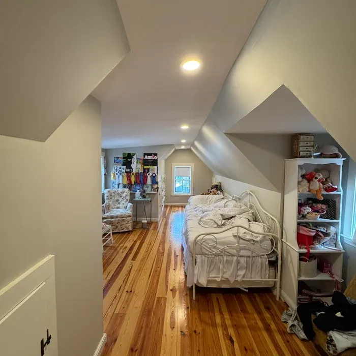 Recessed lighting in a finished attic bedroom
