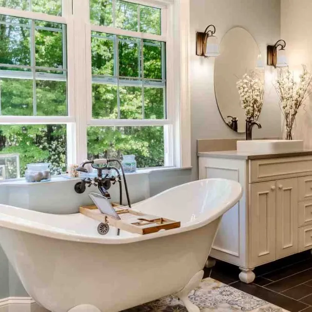 A stylish bathroom with a classic claw foot tub positioned near a window, enhancing the room's ambiance.