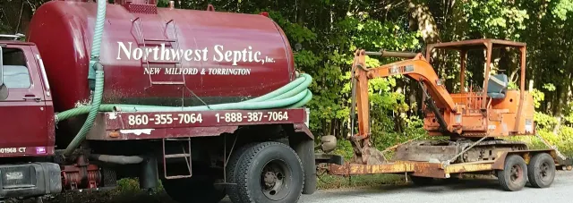 Truck pulling an excavator