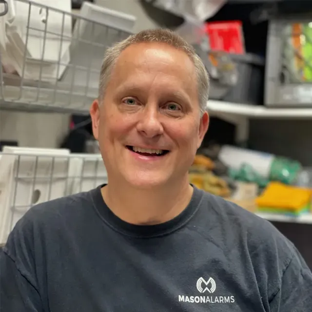 Man smiling, wearing a black shirt with