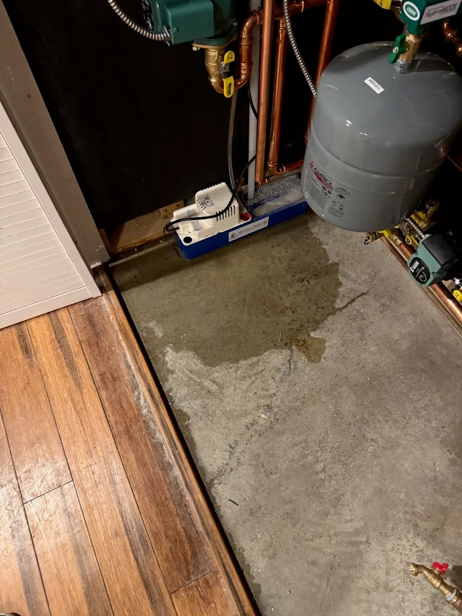 Basement leak at a boiler/expansion tank before repair