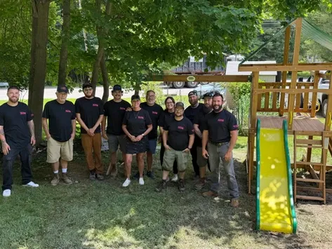 The NU-YAR Construction team builds a custom playset during a ROC Solid Foundation volunteer project.