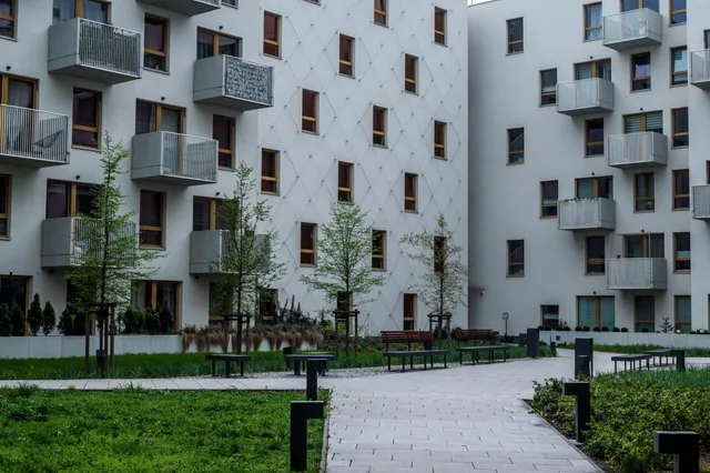 Apartment courtyard with green lawn and walkway