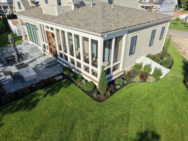 Aerial view of planted garden beds along the gray house and terrace