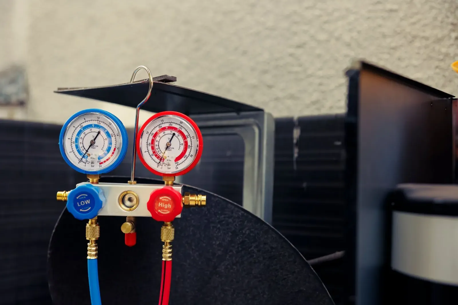 Refrigerant manifold gauges connected to an HVAC unit