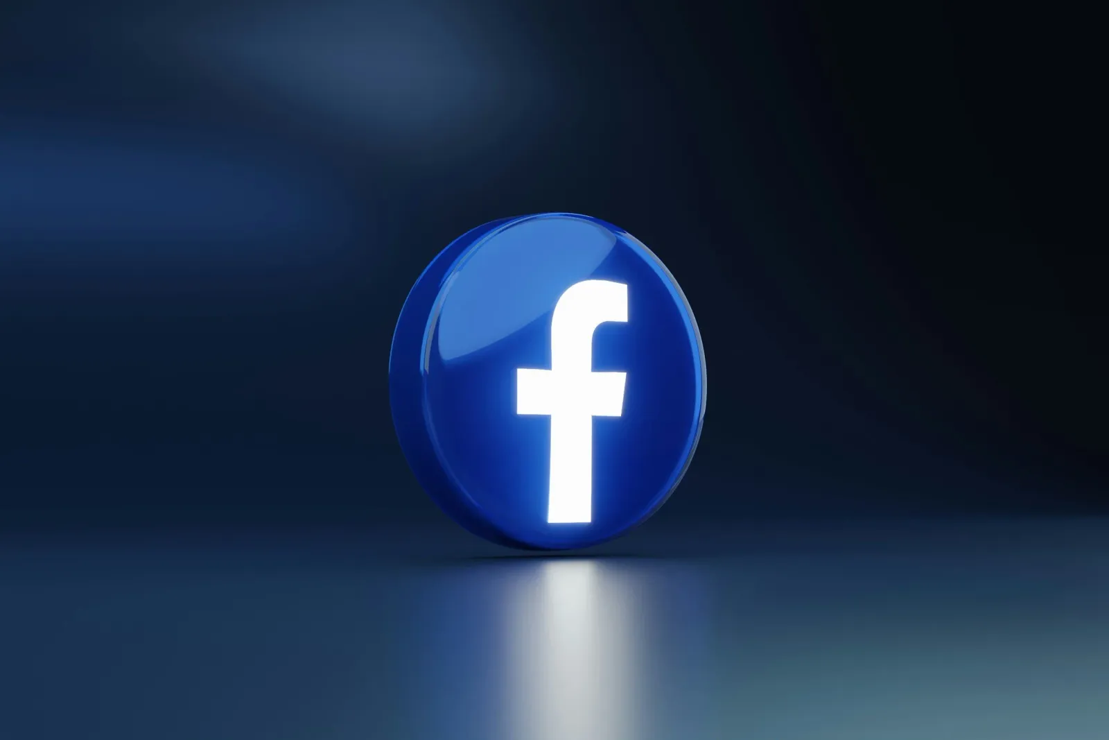 A glowing Facebook logo on a dark background.