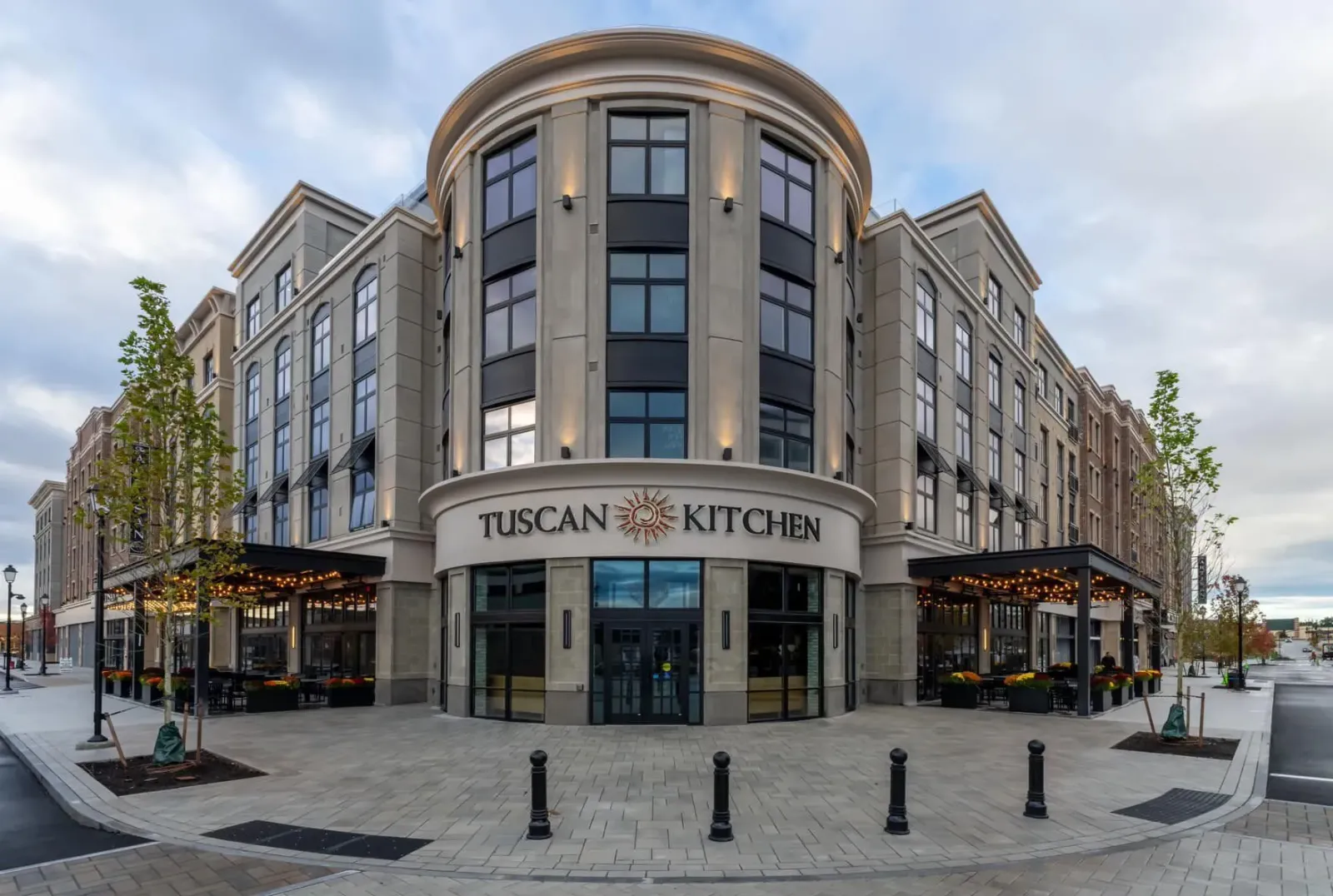 A large building with a sign that says tuscan kitchen.