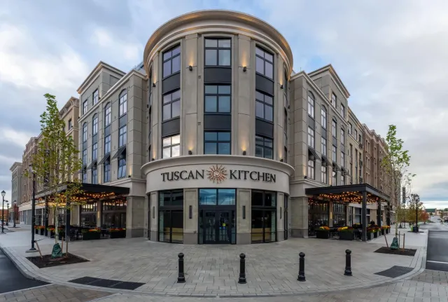 A large building with a sign that says tuscan kitchen.