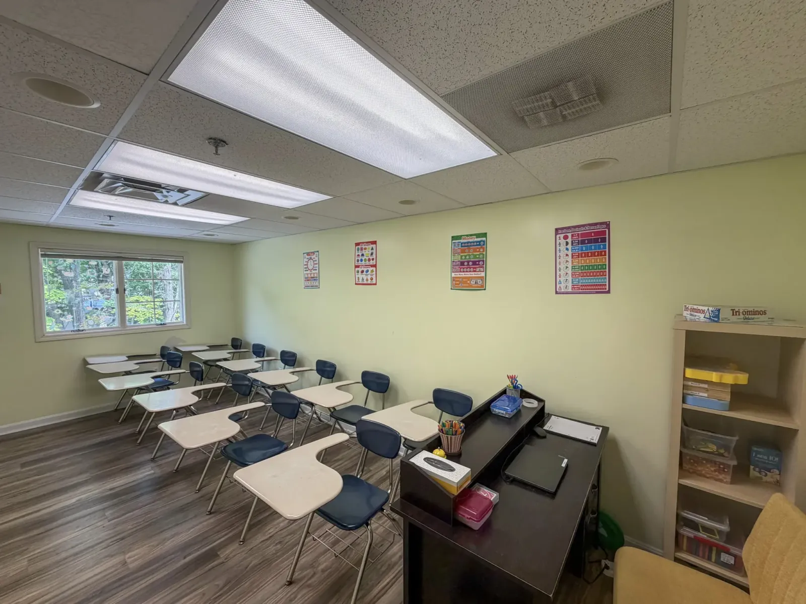 Renovated classroom with new flooring, desks, and bright overhead lighting