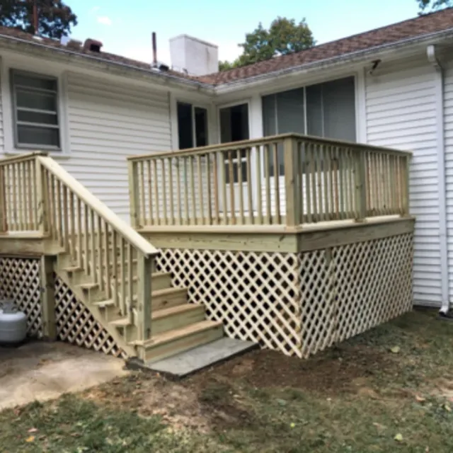 Completed pressure-treated deck with stairs and lattice skirting