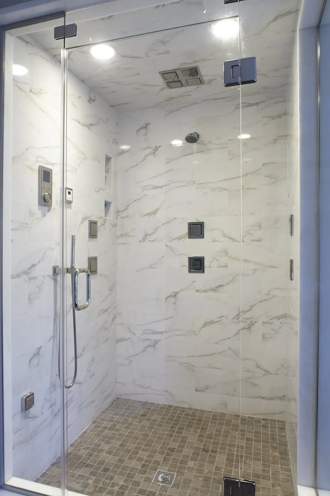 Custom steam shower with body sprays and rain head