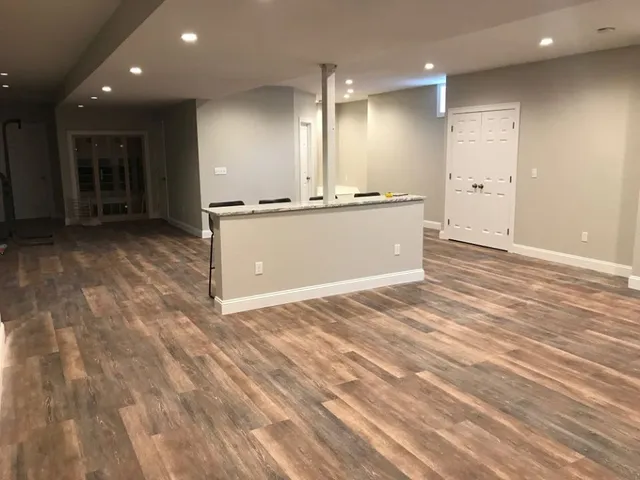 Finished basement with new flooring and kitchenette