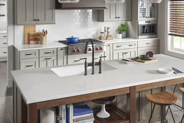 Contemporary kitchen with white cabinetry and quartz island countertop