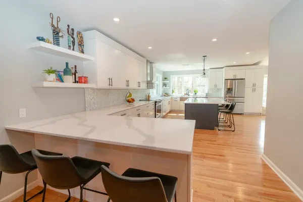 white cabinets with marble countertop kitchen remodel in connecticut by Raymond Design Builders