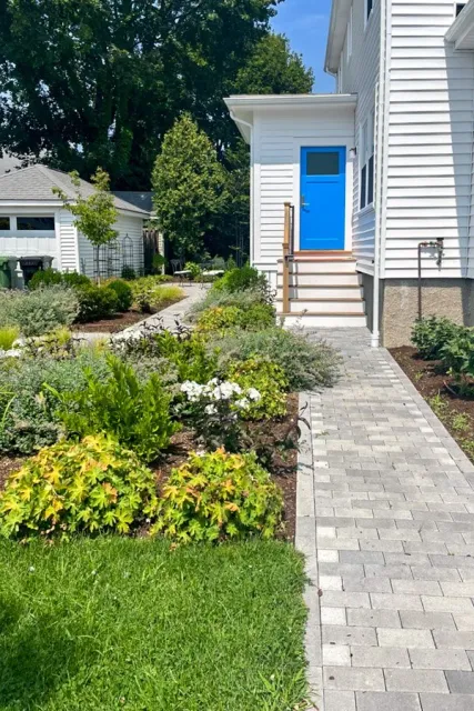 Pathways to house and garage with garden beds of drought tolerant perennials & shrubs