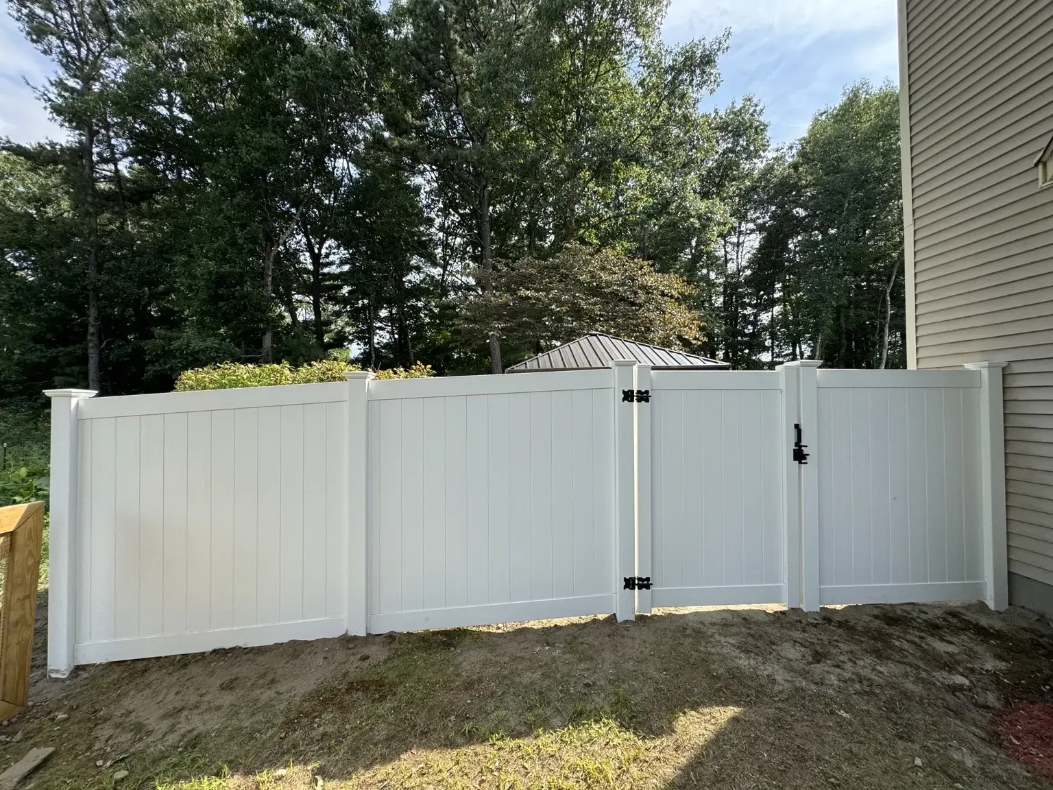 White vinyl privacy fence with a matching gate