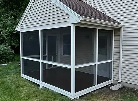 Refurbished screened-in porch with new trim, screens, and paint.