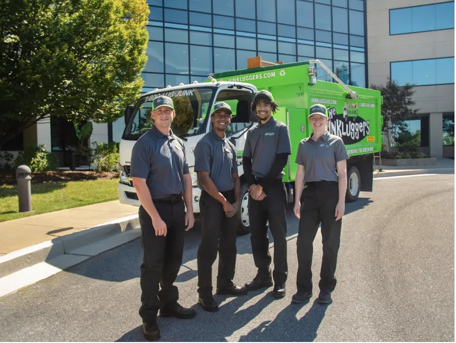 junkluggers team members in front of truck