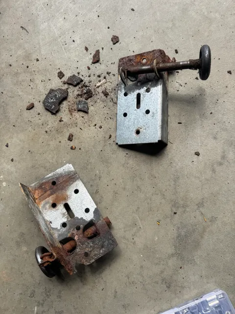 Damaged garage door bottom bracket removed during replacement in Vernon CT