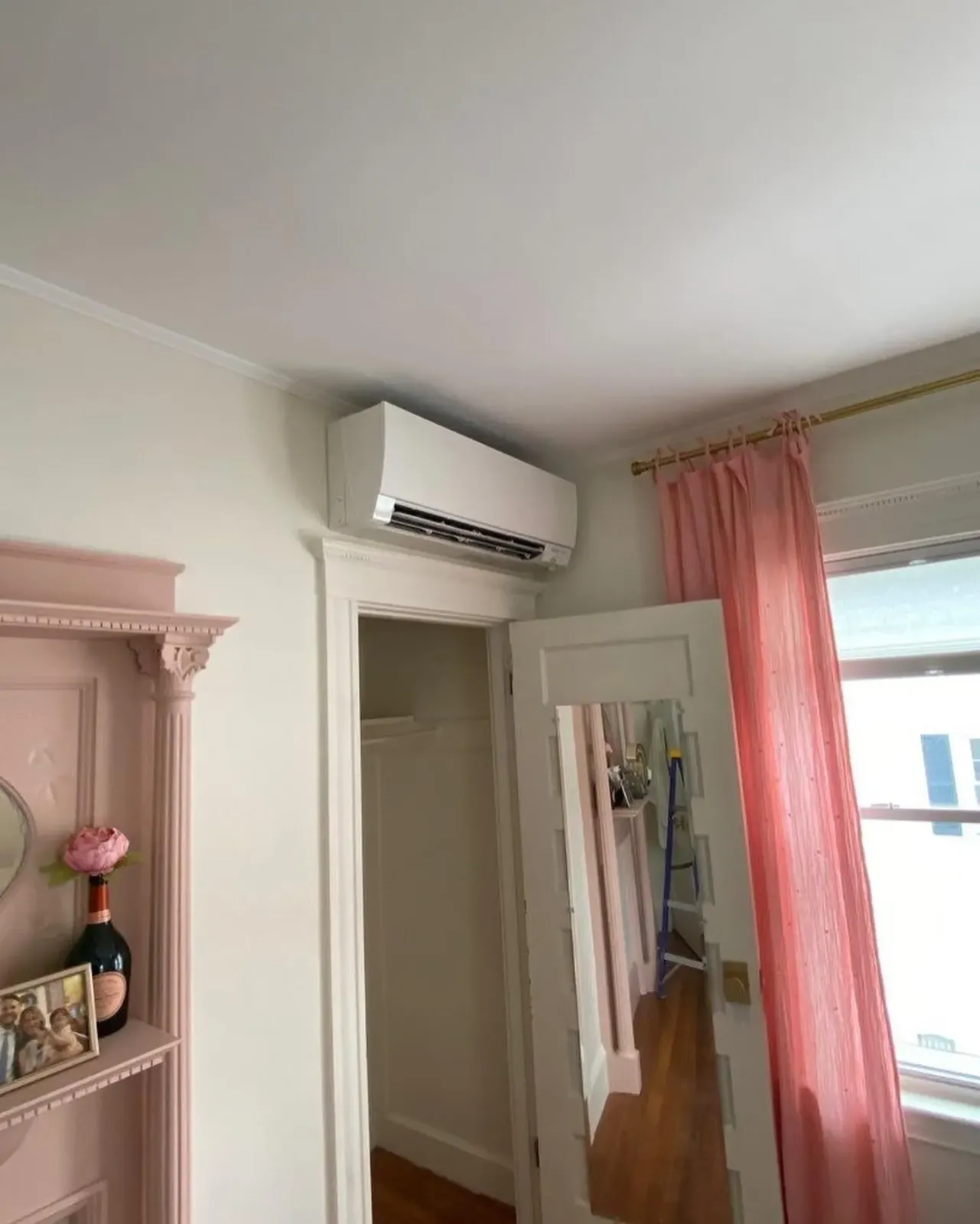 a room with a mirror and a ceiling fan