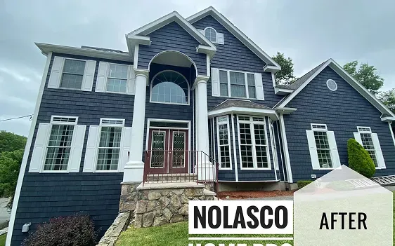 The impeccable facade of a two-story house, with freshly applied exterior paint and in excellent condition, giving it a well-kept, modern, and attractive appearance.
