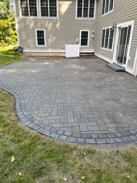 There is a patio in front of a house.