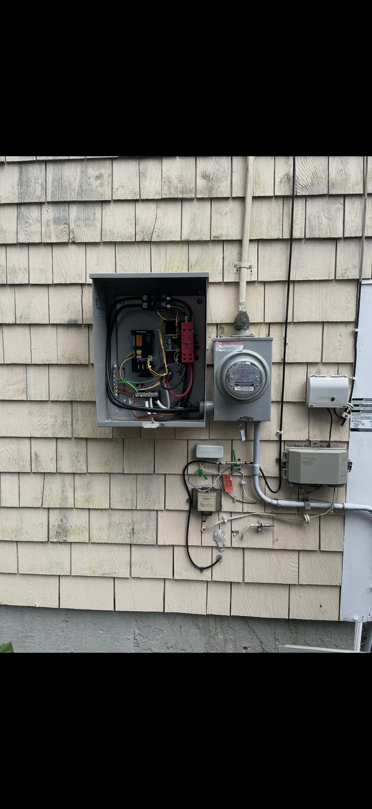 Commercial fit-out in progress in Bristol County, MA showing exposed conduit runs and active install scaffolding