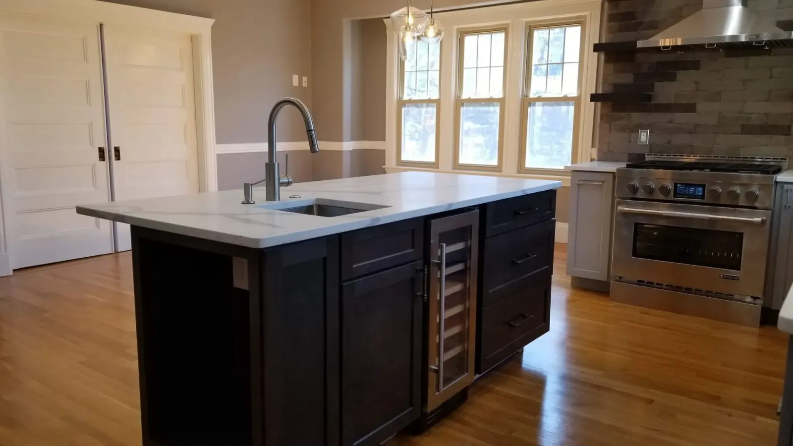 A kitchen with a large island and a sink