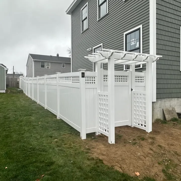 White vinyl privacy fence with lattice-top run and arbor