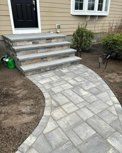 a stone walkway leading to the front door of a house