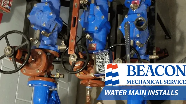 Water main installation equipment featuring blue and orange valves, pipes, and fittings, with a visible logo of Beacon Mechanical Service and the text "WATER MAIN INSTALLS."