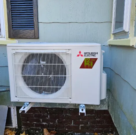 Mitsubishi outdoor heat pump secured on a wall bracket