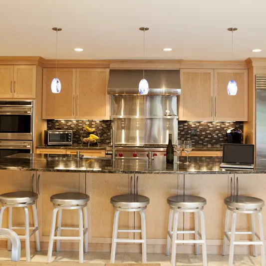 Modern kitchen with light wood cabinets, stainless steel appliances, and a black and gray tile backsplash.