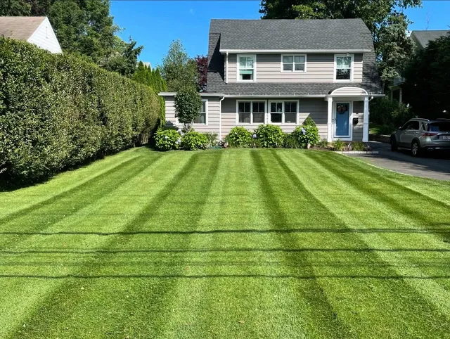 Fresh striped lawn mowing in front of a Fairfield County home