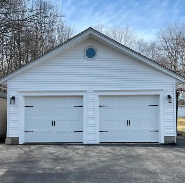 White carriage-style doors on a detached garage
