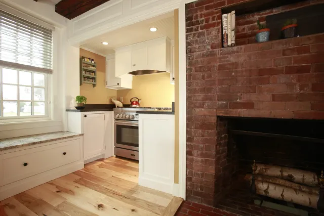 View of fireplace and oven in Seacoast kitchen remodel