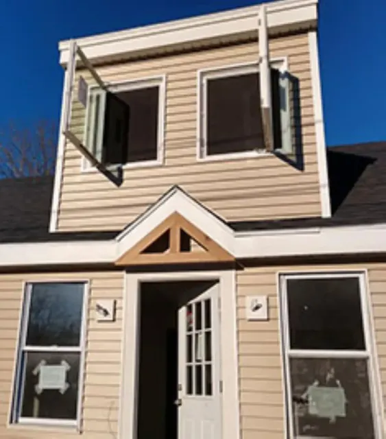 The front of a house with the door open