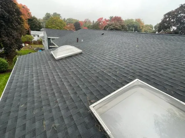 There are two skylights on the roof of a house.