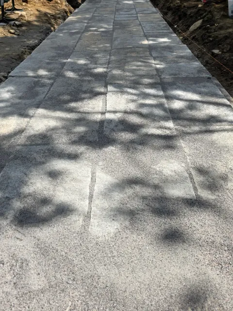 Laid walkway pavers with unfinished edges during construction