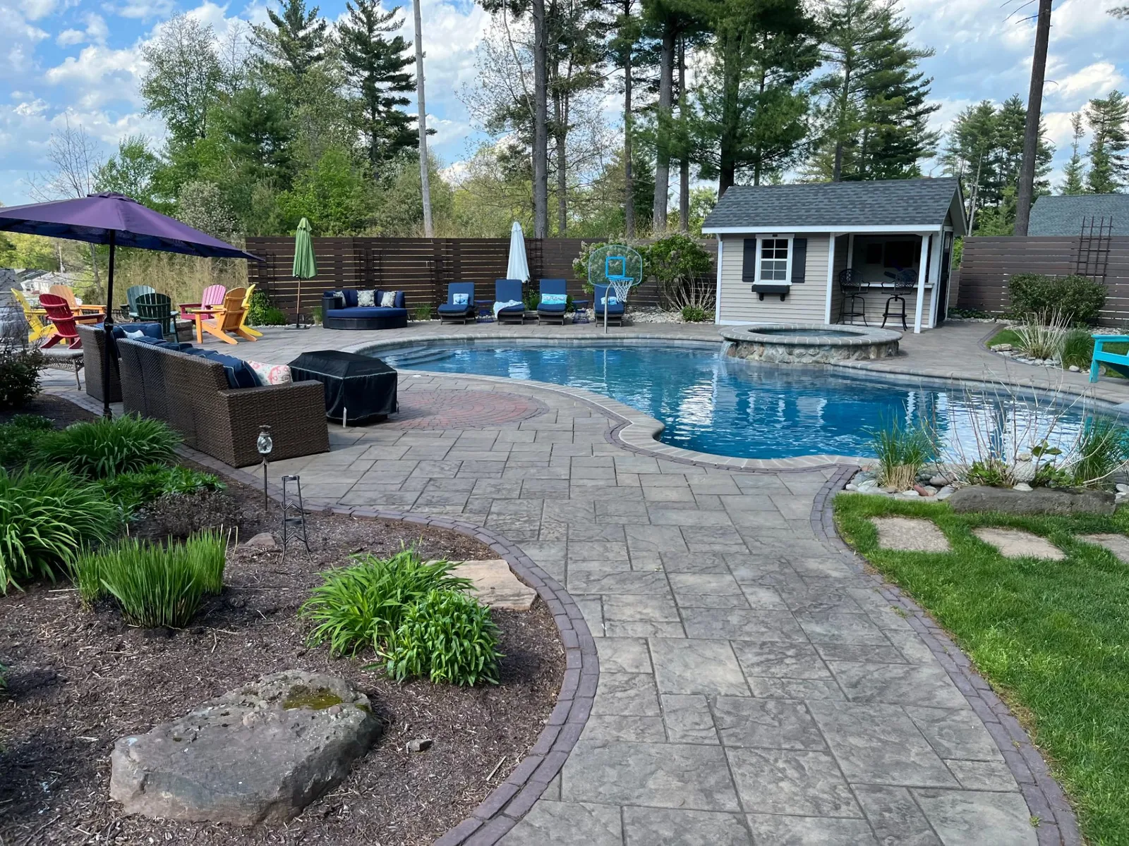 Beautiful residential pool with paver deck and pool house