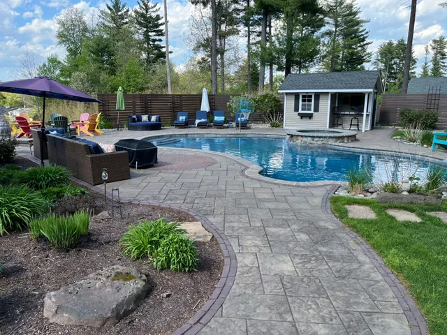 Beautiful residential pool with paver deck and pool house